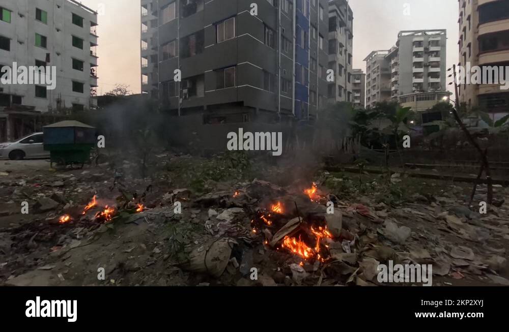 A fire burns in front of apartment buildings in Dhaka, Bangladesh Stock