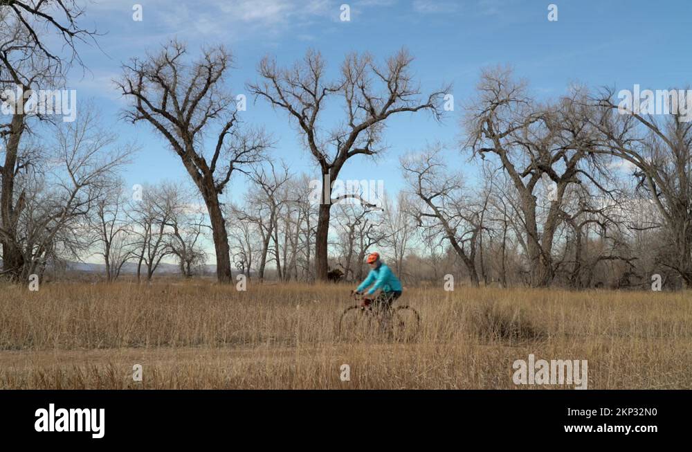 senior male cyclist is riding a gravel bike on a single track trail