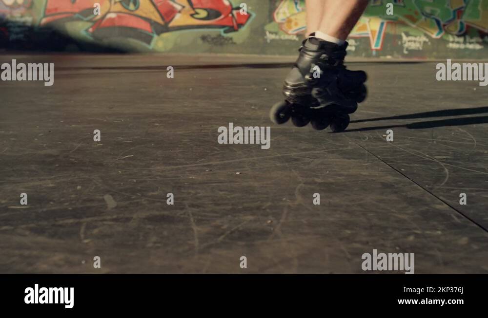 Sporty man performing tricks on roller skates at modern urban skate