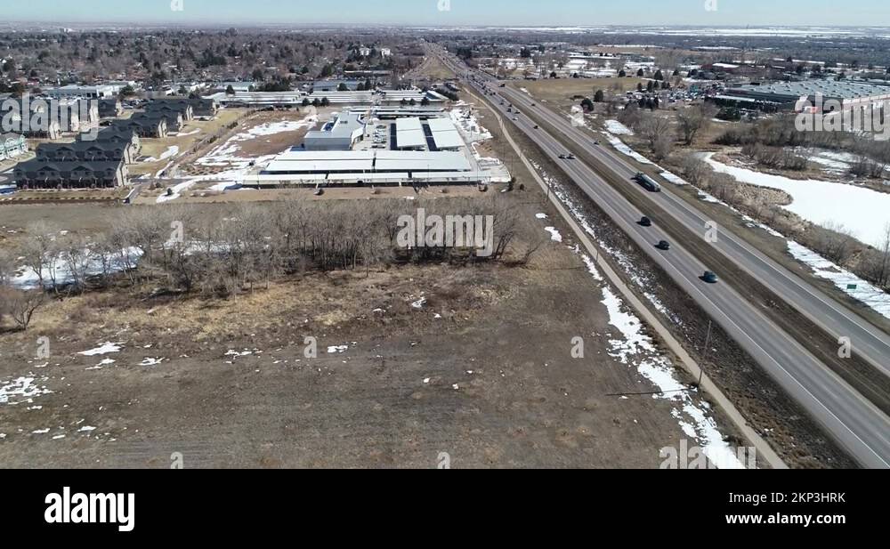 Highway parallel flight showing affordable housing car dealership and