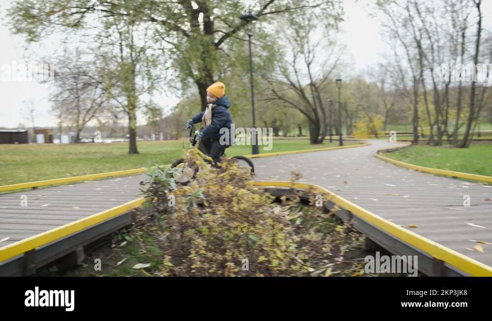 Fall from bike. Child on bicycle riding in city park and falling down Stock Video Footage Alamy