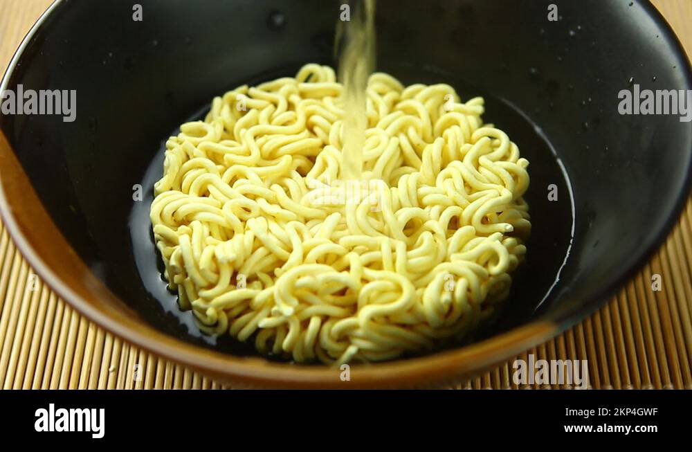 man-is-pouring-hot-water-in-instant-noodles-bowl-in-studio-chiangmai