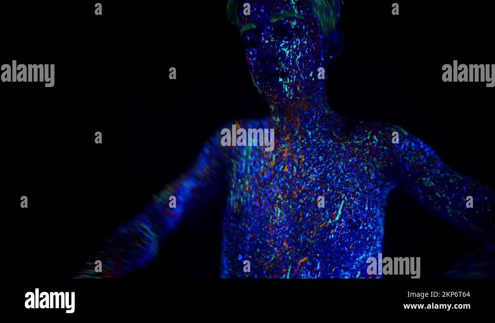 Man covered with phosphor paint dances under ultraviolet light in ...