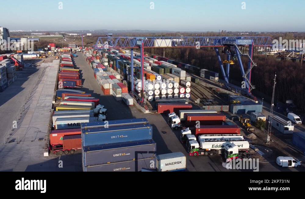 Shipping container crane lift unloading heavy cargo export crate Stock