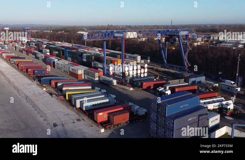 Shipping container crane lift unloading heavy cargo export crate Stock