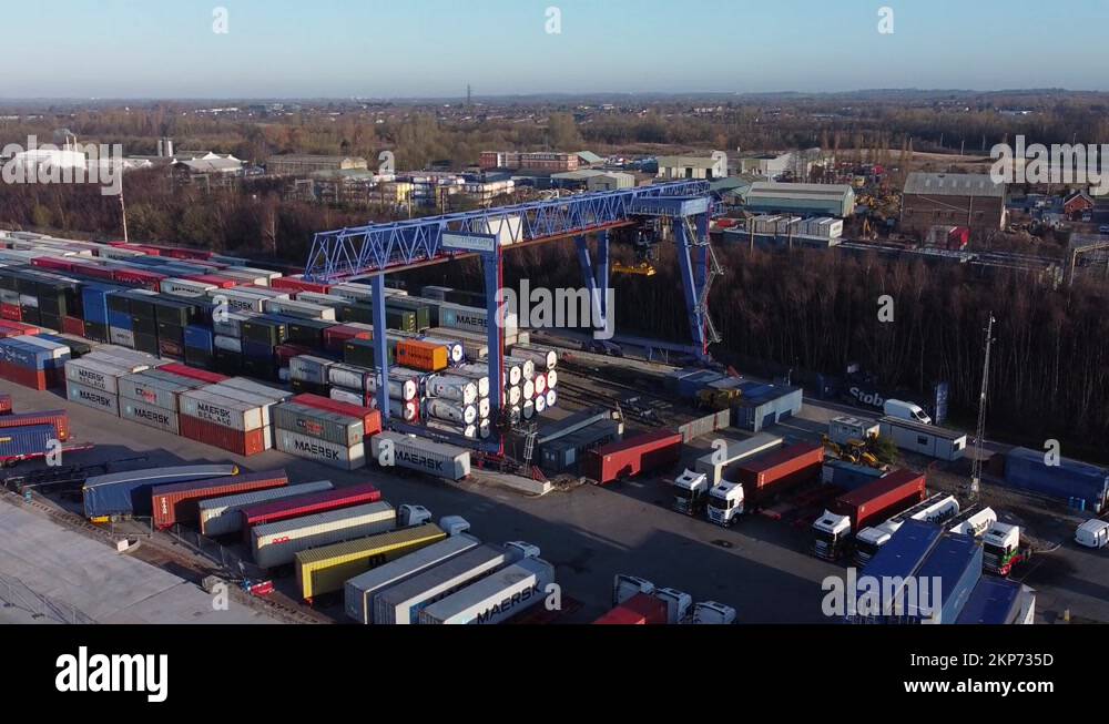Shipping container crane lift unloading heavy cargo export crate Stock