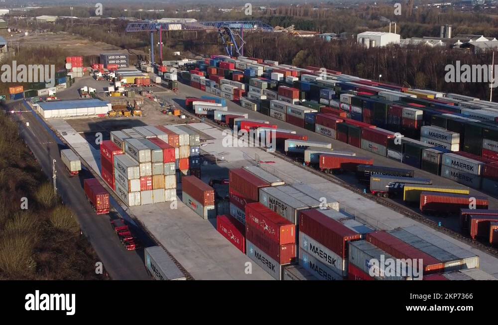 Shipping container crane lift unloading heavy cargo export crate Stock