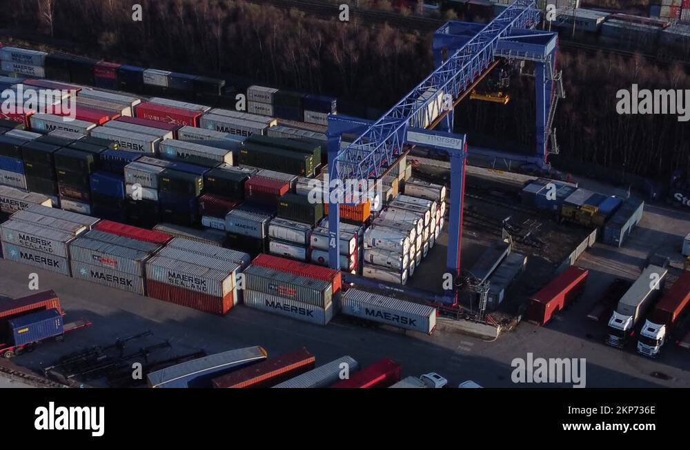 Shipping container crane lift unloading heavy cargo export crate Stock