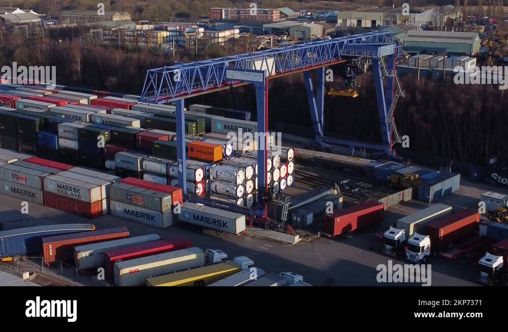 Shipping container crane lift unloading heavy cargo export crate Stock