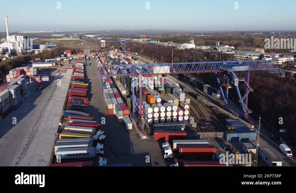 Shipping container crane lift unloading heavy cargo export crate Stock