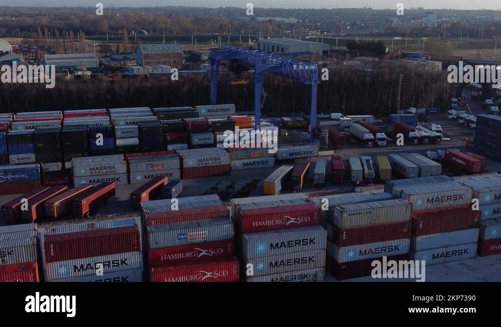 Shipping container crane lift unloading heavy cargo export crate Stock