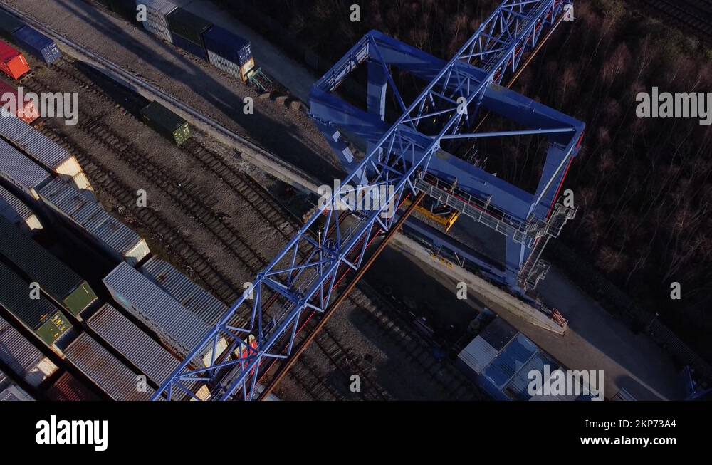 Shipping container crane lift unloading heavy cargo export crate Stock