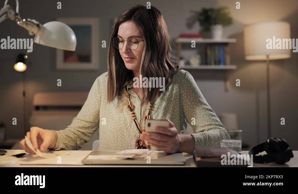 Check counting, housekeeping. Woman enters data from paid checks into ...