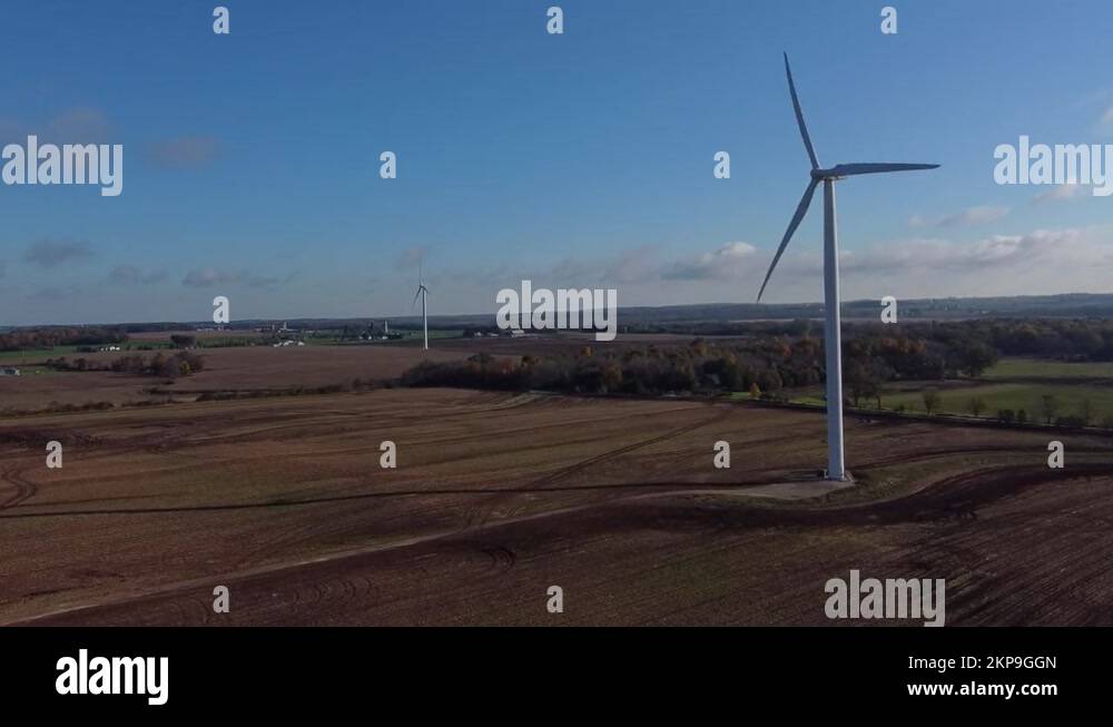 Wind Turbine Spinning Right in Farm Field, Aerial Drone Push Stock