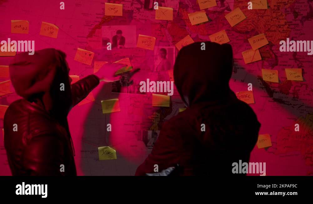 Two Caucasian young men looking at wall map with strings Stock Video