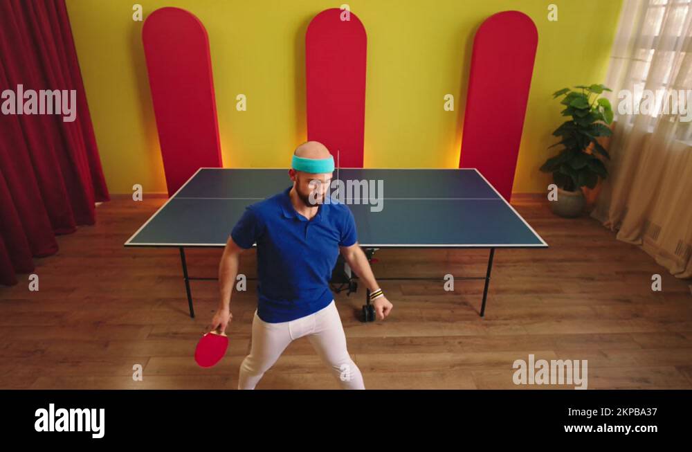 Handsome guy ping pong player get ready for the game holding his racket
