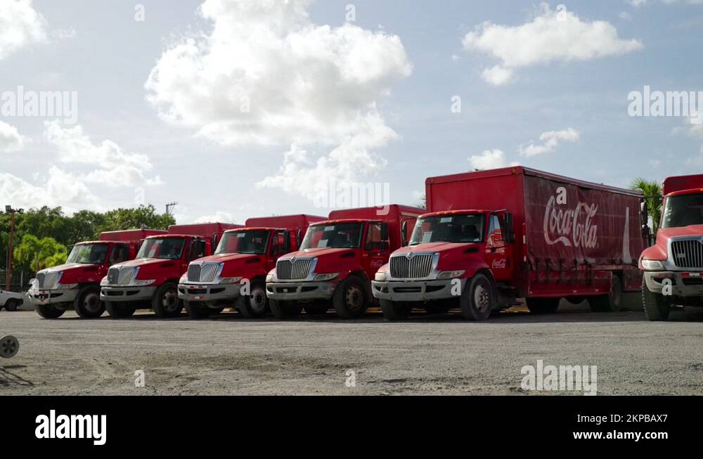 Row Of Parked Coca Cola Trucks At Distribution Center In Punta Cana