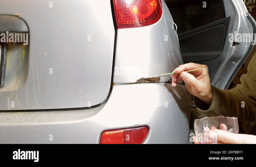 paint rust and corrosion on the car with a brush with a rust converter