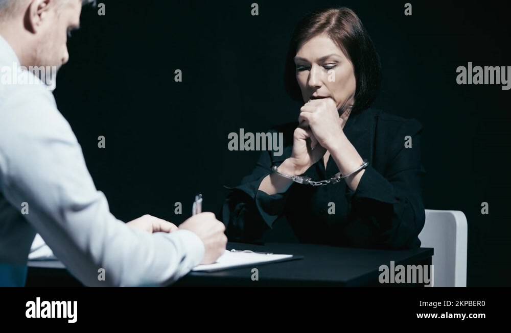 Handcuffed female arrested on fraud suspicion answering detective