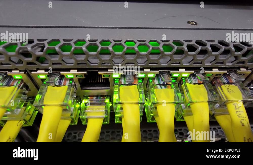 Network switch with yellow cables and flashing lights