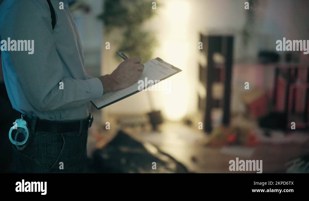 Closeup of detective filling out reports, documenting evidence at