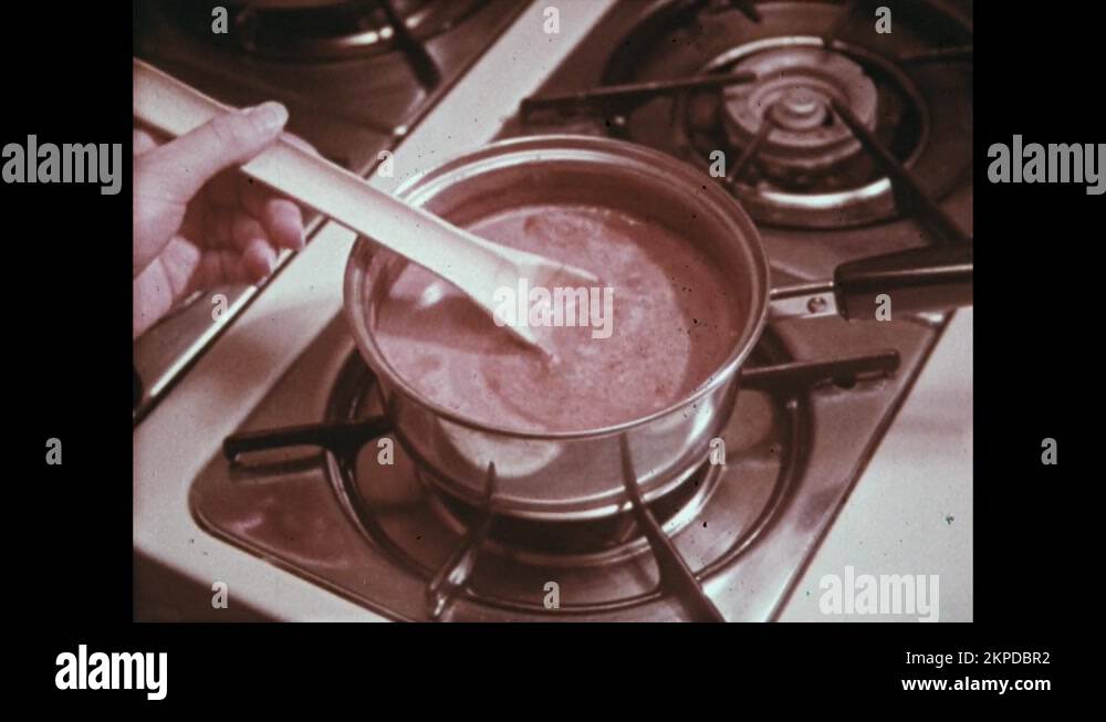 1970s Stirring liquid on the stove. Finger wiped across book, dust