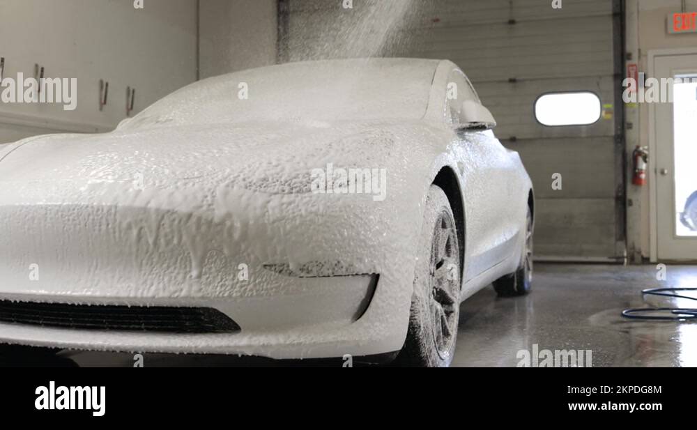 Tesla Model 3 getting carwash with foam cannon Stock Video Footage Alamy
