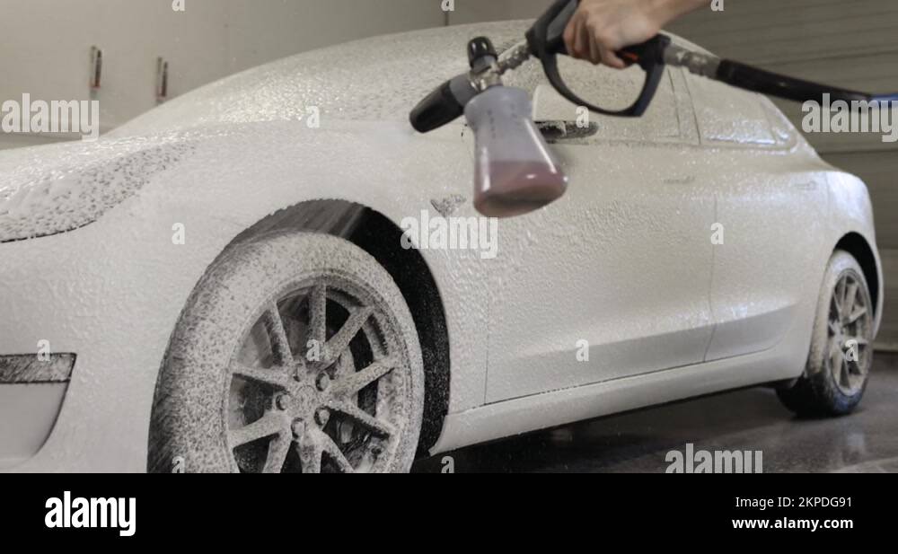 Tesla Model 3 getting carwash with foam cannon Stock Video Footage Alamy