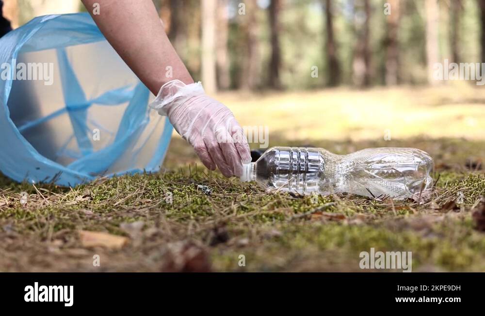 Clean up day. hands cleaning forest or park from garbage. Ecology