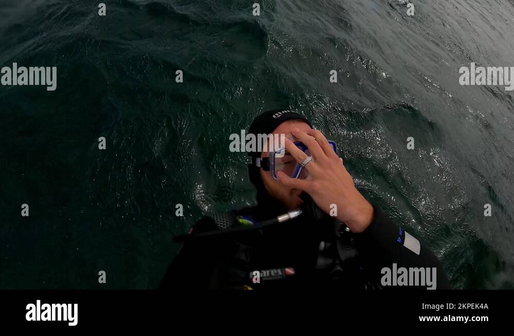 Scuba Diver Diving Backwards Off The Boat Into The Sea. slow motion