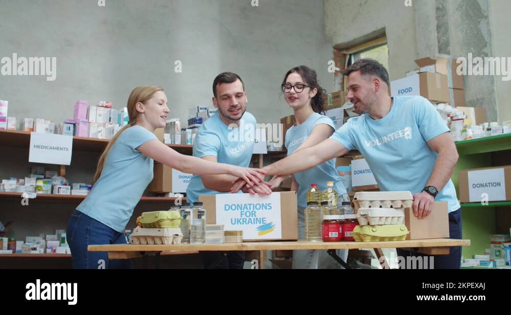 Group of people stacking hands together for showing unity and teamwork ...