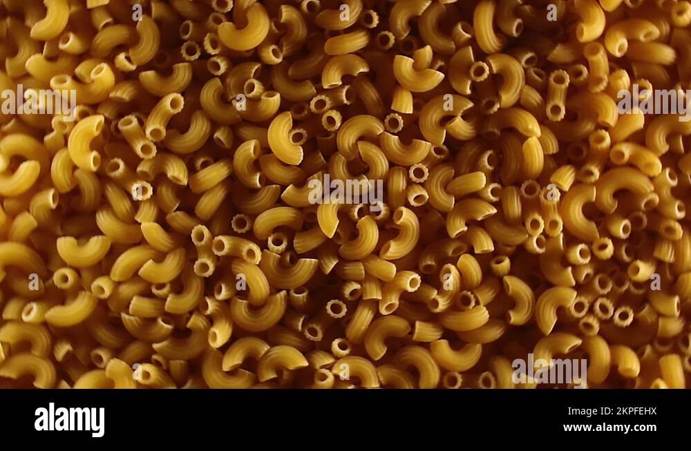 Uncooked Chifferi Rigati Pasta, Scattered Dry Macaroni Rotating