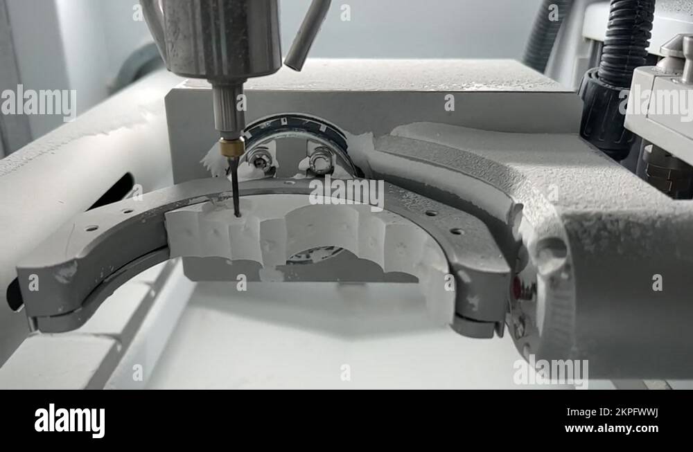 CNC dental milling machine carving out shape of artificial teeth in the