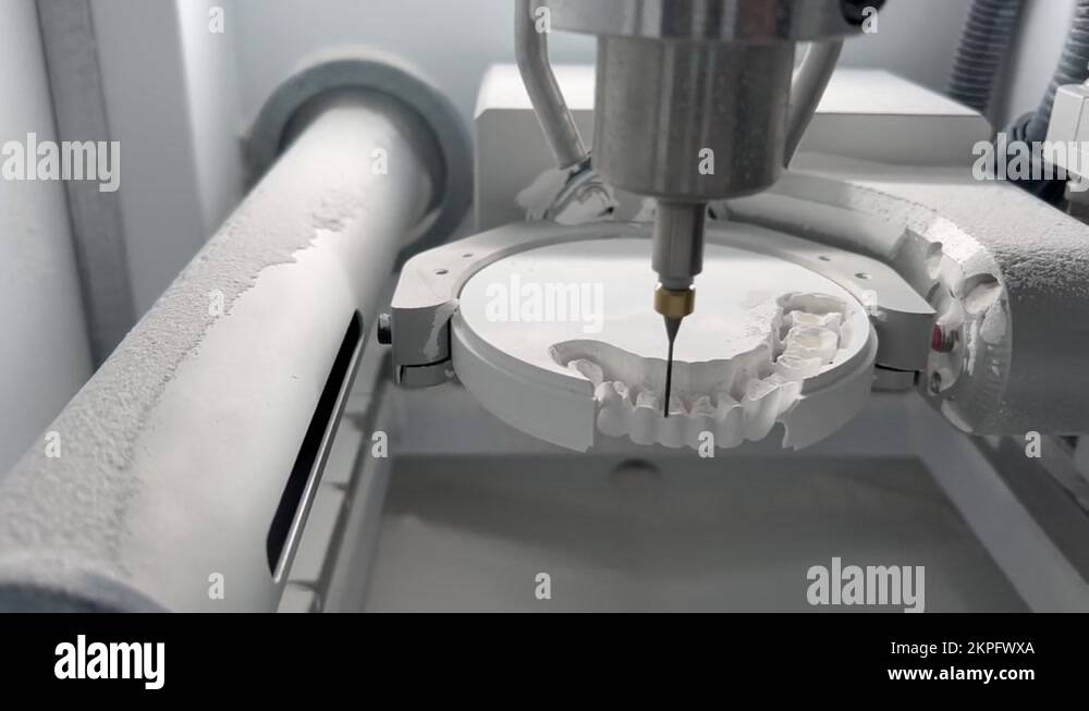 CNC dental milling machine carving out shape of artificial teeth in the
