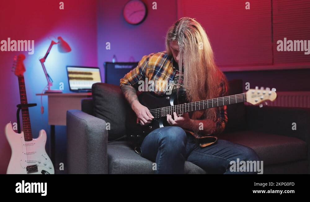 Musician uses tapping technique to play the electric guitar,playing on