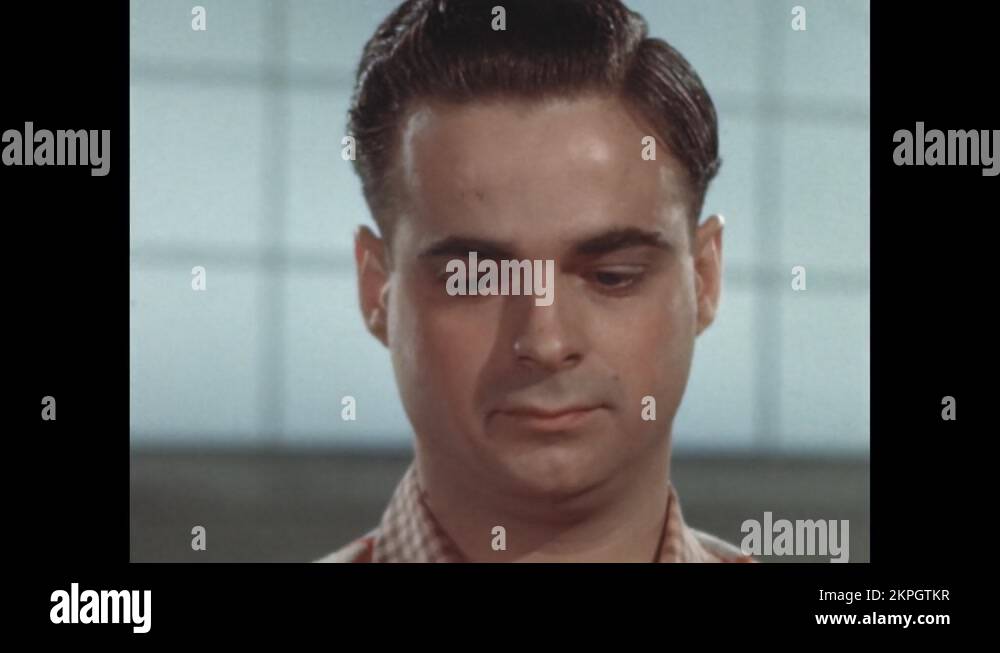 1940s man looks down as his eyes dart back and forth. A page of a book Stock Video