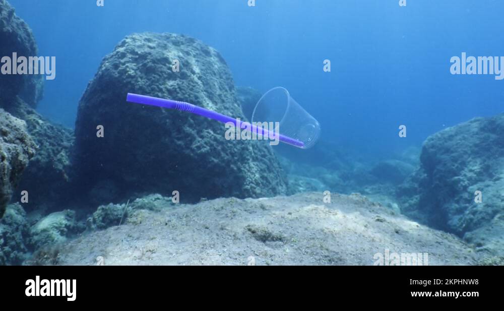 pollution of oceans underwater plastic cup with straw sun beams and rays Stock Video Footage Alamy