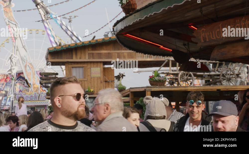 Crowds walking while people drink on a rotating bar stand at Balvarian