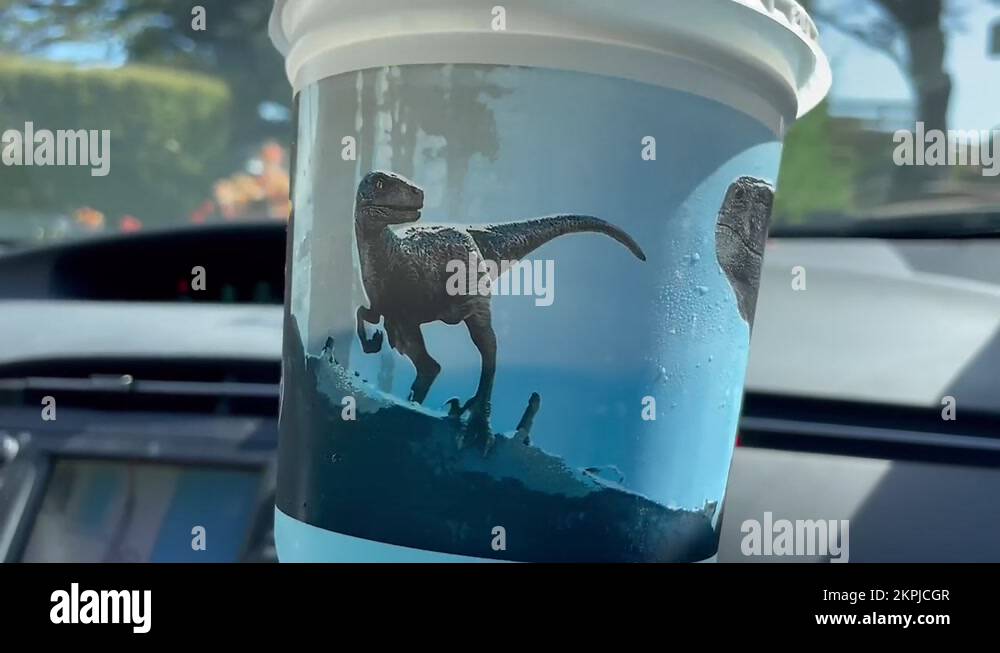 Jurassic World Dominion dinosaur themed menu at Carl's Jr Stock Video