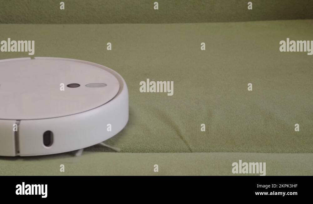 Robot vacuum cleaner vacuuming the bed in the bedroom Stock Video