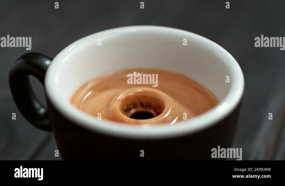 Espresso Droplet Falling into the Coffee Cup with Foamy Crema Stock