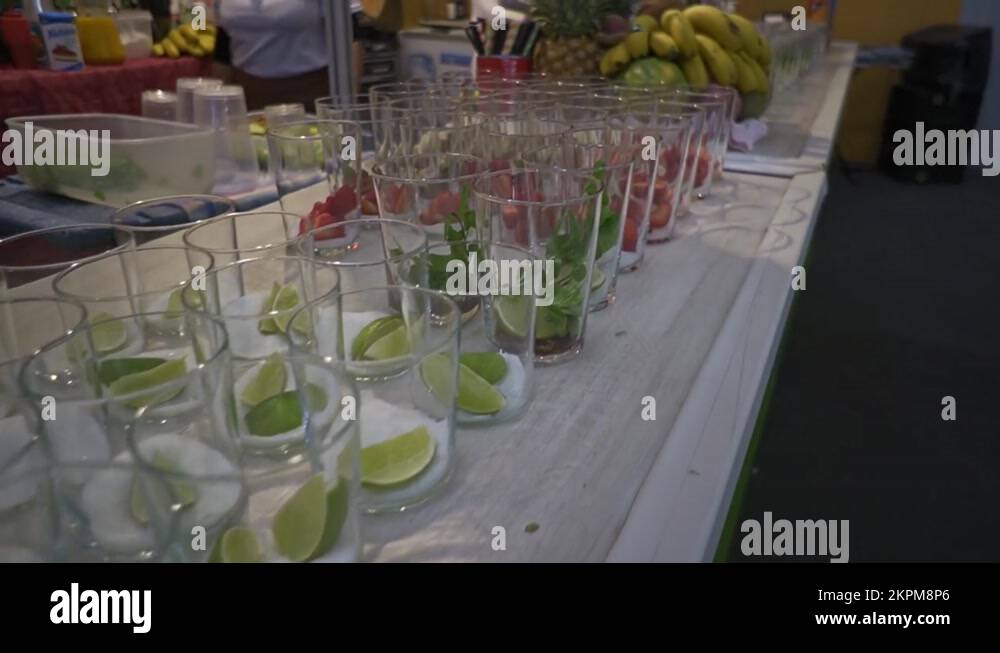 Glasses on bar counter prepared with fruits to make cocktails. Dolly ...