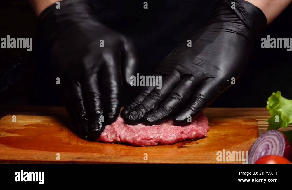 Chef mixing ground beef and shaping a burger patty Stock Video Footage