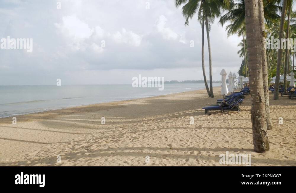 Luxury beach lounge beds with umbrella on white sand beach. beach with