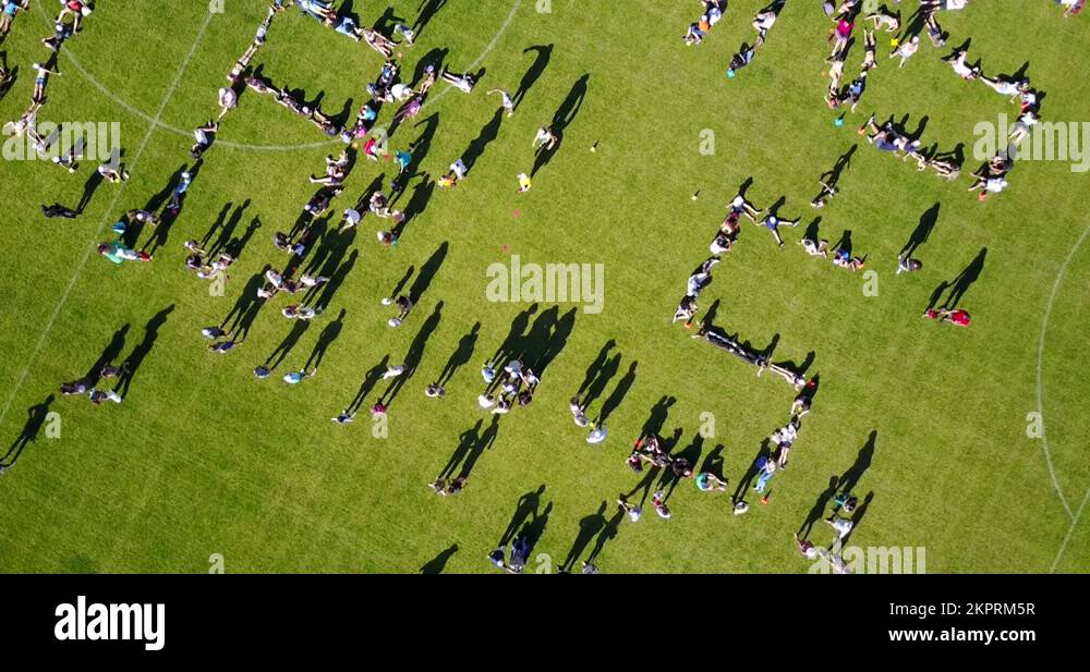 A Crowd Spelling Out Letters Using Their Human Bodies As Words In The