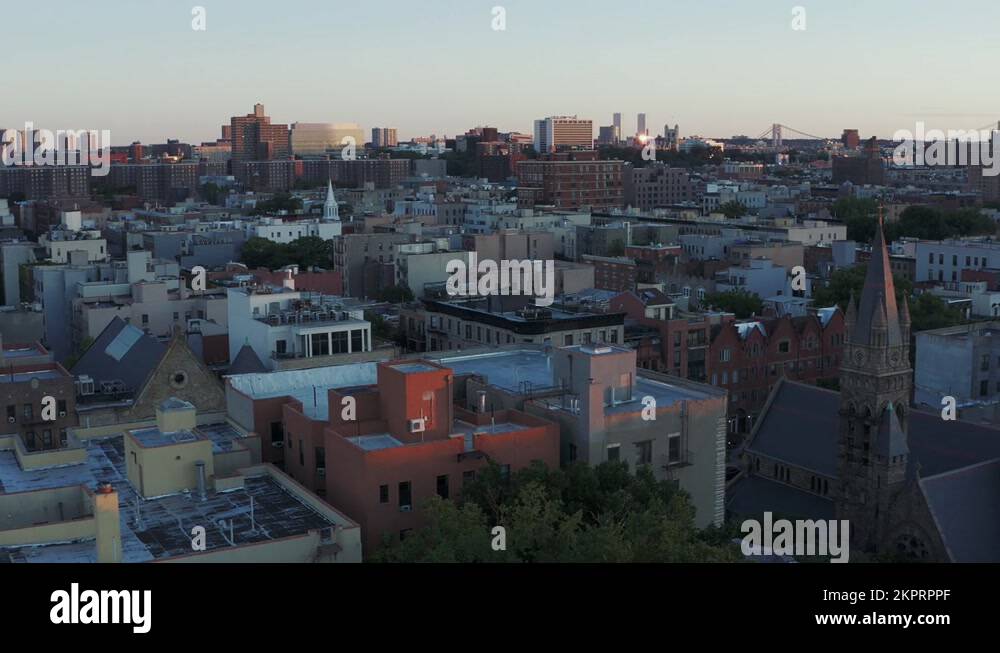 Crispy long pan across the rooftops of Harlem NYC ending in a sun flare