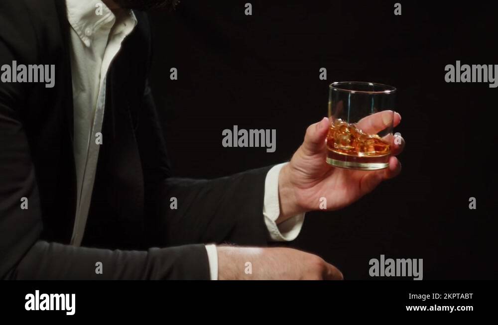 Drinking brandy or whiskey close-up. Rich man drinks luxury cognac on ...