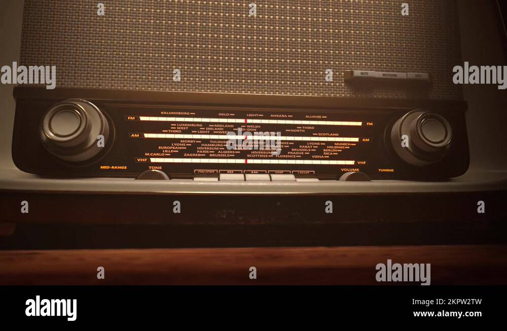 Old vintage radio changing frequency tuning to radio stations. Night in
