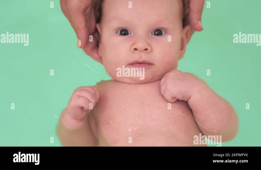 Mom teaches a newborn baby to swim and stay on the water. A twomonthold bab Stock Video