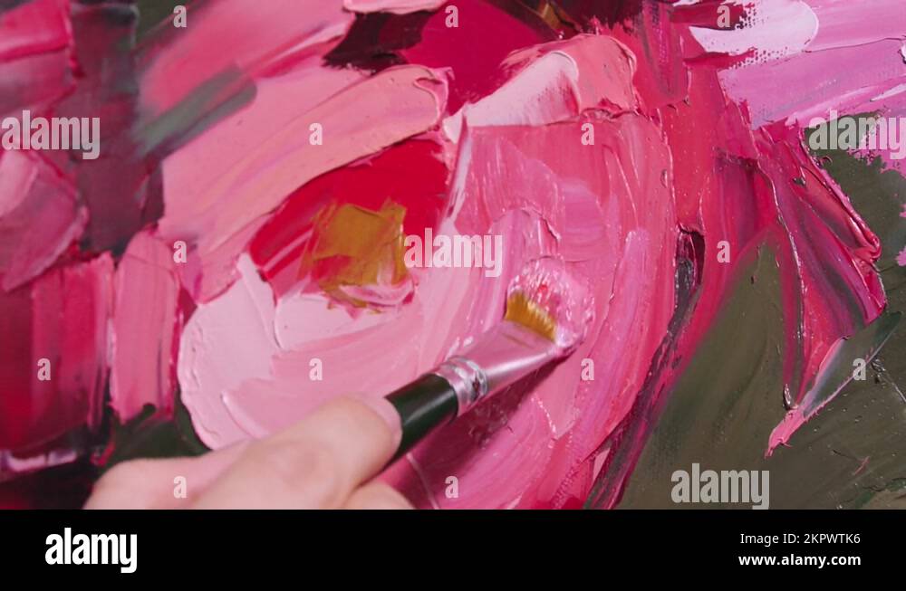 Artist hand is painting the visible brush strokes on the canvas. paint